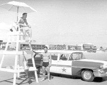 Lifeguards on the beach 1960s black and white photo